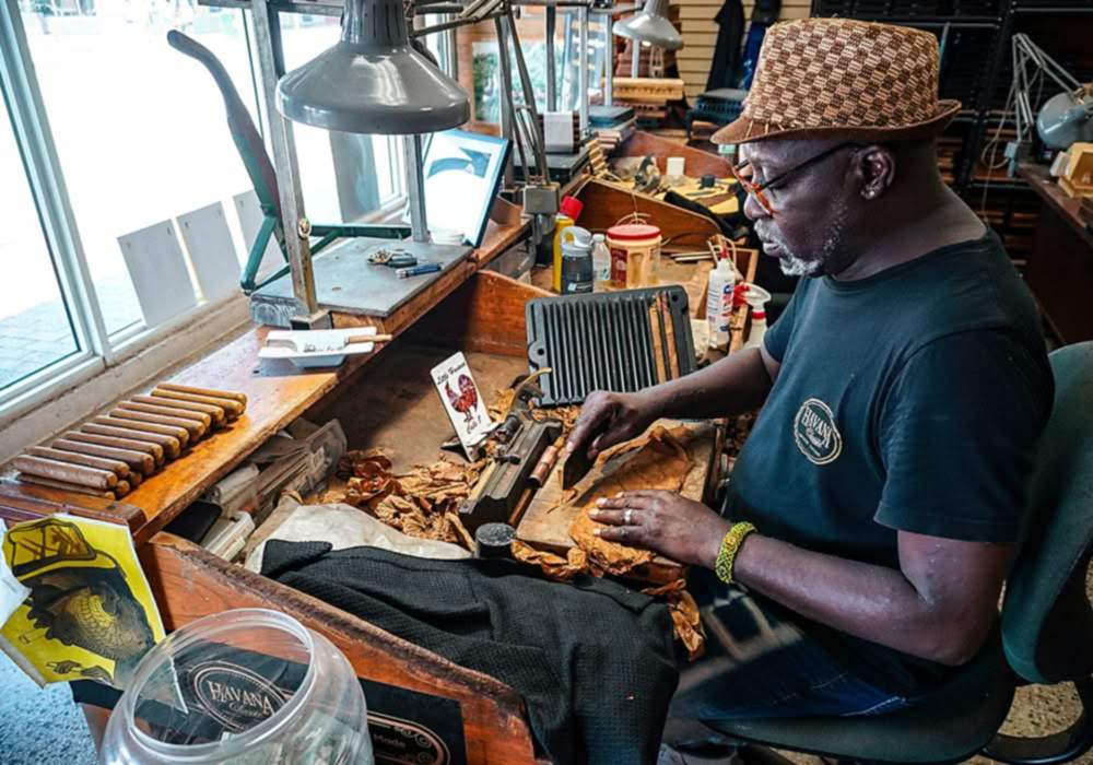 Cigar roller at work in a Little Havana cigar shop, Calle Ocho, Miami.